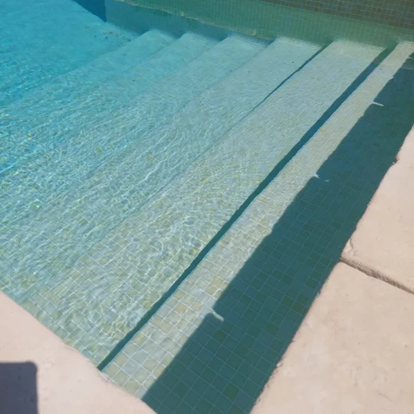 Diseño refinado con gresite para piscina en color beige en formato compacto